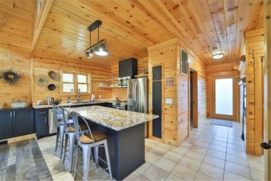 Enjoy relaxing on the large 10x30 deck overlooking the 11th hole on Hardwoods Golf Club At Mille Lacs in Minnesota - for sale on GolfHomes.com, golf home, golf lot