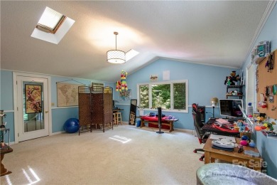 This contemporary mountain home situated on a private wooded lot on Mt. Mitchell Golf Course in North Carolina - for sale on GolfHomes.com, golf home, golf lot