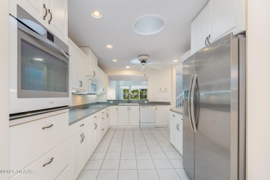 This end-unit villa condominium offers scenic golf course views on Spruce Creek Golf Club in Florida - for sale on GolfHomes.com, golf home, golf lot
