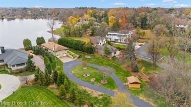 Experience the charm and tranquility of lakefront living in this on Forest Lake Country Club in Michigan - for sale on GolfHomes.com, golf home, golf lot