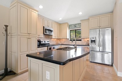 Spectacular turnkey 2BR/2BA Club Cottage with serene canal views on PGA National Golf Club in Florida - for sale on GolfHomes.com, golf home, golf lot