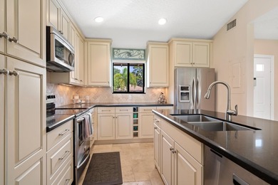 Spectacular turnkey 2BR/2BA Club Cottage with serene canal views on PGA National Golf Club in Florida - for sale on GolfHomes.com, golf home, golf lot