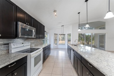 Welcome to the perfect Florida retreat where lush green fairways on Oakwood Golf Club in Florida - for sale on GolfHomes.com, golf home, golf lot