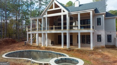 Indulge in opulent living within this custom 5-bedroom, 5.5-bath on Reynolds Lake Oconee - The Oconee in Georgia - for sale on GolfHomes.com, golf home, golf lot