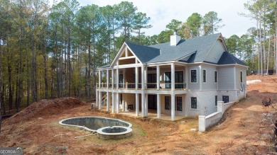 Indulge in opulent living within this custom 5-bedroom, 5.5-bath on Reynolds Lake Oconee - The Oconee in Georgia - for sale on GolfHomes.com, golf home, golf lot