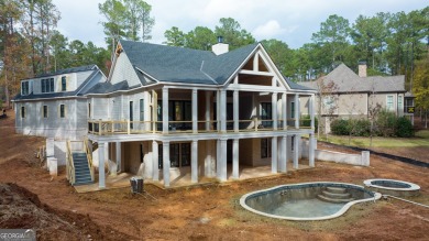 Indulge in opulent living within this custom 5-bedroom, 5.5-bath on Reynolds Lake Oconee - The Oconee in Georgia - for sale on GolfHomes.com, golf home, golf lot