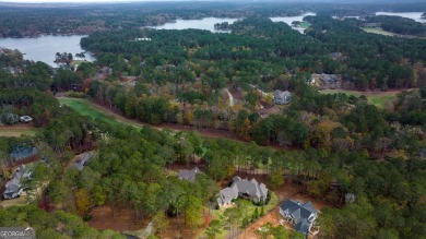 Indulge in opulent living within this custom 5-bedroom, 5.5-bath on Reynolds Lake Oconee - The Oconee in Georgia - for sale on GolfHomes.com, golf home, golf lot