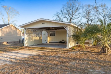 This charming residence is ideally located near the beach on Oyster Bay Golf Links in North Carolina - for sale on GolfHomes.com, golf home, golf lot