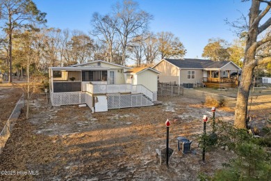 This charming residence is ideally located near the beach on Oyster Bay Golf Links in North Carolina - for sale on GolfHomes.com, golf home, golf lot