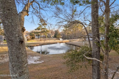 This charming residence is ideally located near the beach on Oyster Bay Golf Links in North Carolina - for sale on GolfHomes.com, golf home, golf lot