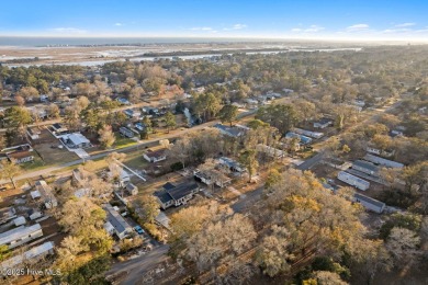 This charming residence is ideally located near the beach on Oyster Bay Golf Links in North Carolina - for sale on GolfHomes.com, golf home, golf lot