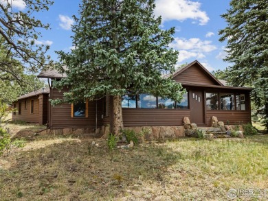 Classic 1920s Estes Park cabin in beautiful condition and full on Estes Park Golf Course in Colorado - for sale on GolfHomes.com, golf home, golf lot