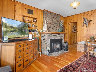 Classic 1920s Estes Park cabin in beautiful condition and full on Estes Park Golf Course in Colorado - for sale on GolfHomes.com, golf home, golf lot