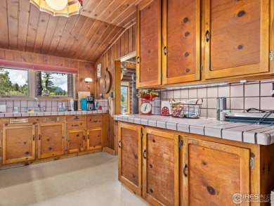 Classic 1920s Estes Park cabin in beautiful condition and full on Estes Park Golf Course in Colorado - for sale on GolfHomes.com, golf home, golf lot