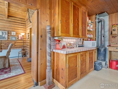 Classic 1920s Estes Park cabin in beautiful condition and full on Estes Park Golf Course in Colorado - for sale on GolfHomes.com, golf home, golf lot