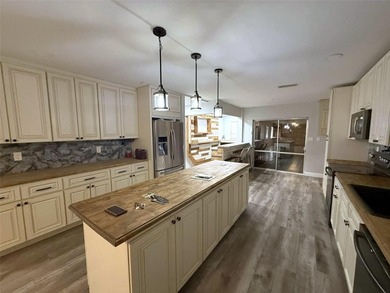 Short Sale. This LARGE 4/2/2 pool home sits on a peaceful on Port Charlotte Golf Club in Florida - for sale on GolfHomes.com, golf home, golf lot