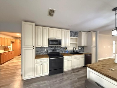 Short Sale. This LARGE 4/2/2 pool home sits on a peaceful on Port Charlotte Golf Club in Florida - for sale on GolfHomes.com, golf home, golf lot