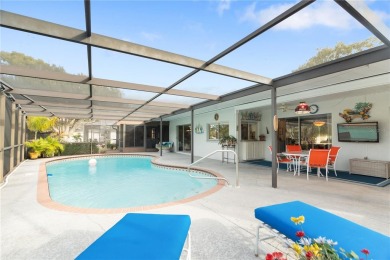 This beautifully maintained 3-bedroom, 2-bathroom pool home on Beacon Woods Golf Club in Florida - for sale on GolfHomes.com, golf home, golf lot