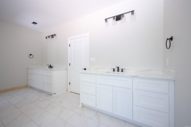 This stunning 5-bedroom, 3-bath brick home offers modern design on The Course At Eagle Mountain in Arkansas - for sale on GolfHomes.com, golf home, golf lot