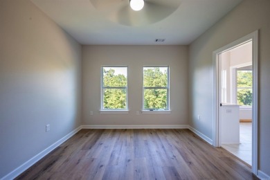 This stunning 5-bedroom, 3-bath brick home offers modern design on The Course At Eagle Mountain in Arkansas - for sale on GolfHomes.com, golf home, golf lot