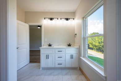 This stunning 5-bedroom, 3-bath brick home offers modern design on The Course At Eagle Mountain in Arkansas - for sale on GolfHomes.com, golf home, golf lot