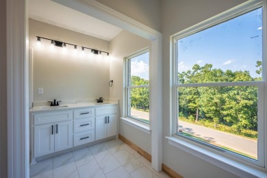 This stunning 5-bedroom, 3-bath brick home offers modern design on The Course At Eagle Mountain in Arkansas - for sale on GolfHomes.com, golf home, golf lot