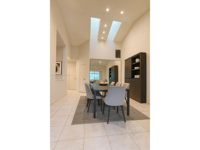 Enjoy gorgeous water views from the main living areas and the on Woodmont Country Club in Florida - for sale on GolfHomes.com, golf home, golf lot