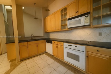 Enjoy gorgeous water views from the main living areas and the on Woodmont Country Club in Florida - for sale on GolfHomes.com, golf home, golf lot