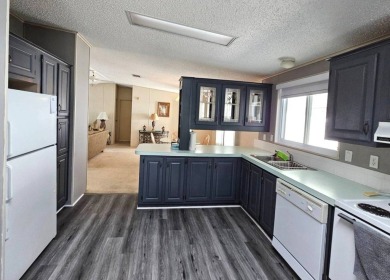 This home is on leased land, meaning buyers do not own the land on Big Cypress Golf and Country Club in Florida - for sale on GolfHomes.com, golf home, golf lot