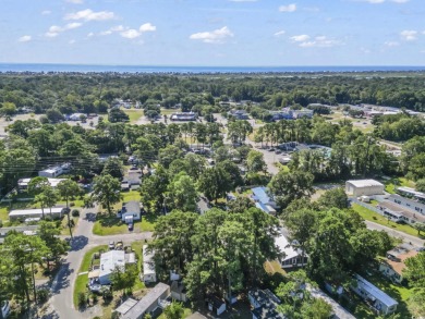 Nestled in the warm embrace of Murrells Inlet's scenic coastal on Indian Wells Golf Course in South Carolina - for sale on GolfHomes.com, golf home, golf lot
