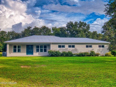 Country living meets modern convenience in this serene wooded on New Smyrna Beach Golf Course in Florida - for sale on GolfHomes.com, golf home, golf lot