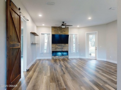 Country living meets modern convenience in this serene wooded on New Smyrna Beach Golf Course in Florida - for sale on GolfHomes.com, golf home, golf lot