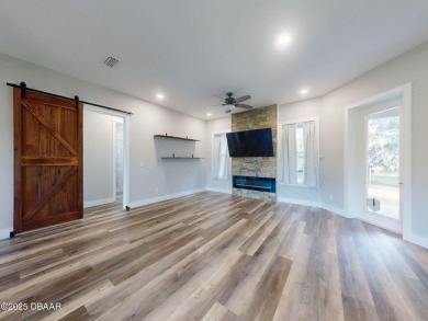 Country living meets modern convenience in this serene wooded on New Smyrna Beach Golf Course in Florida - for sale on GolfHomes.com, golf home, golf lot