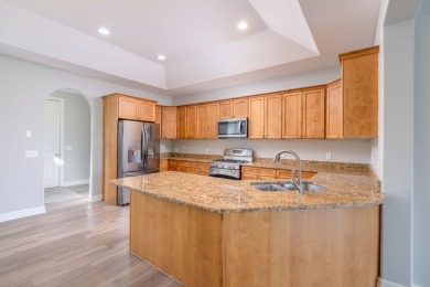 Experience refined waterfront living at its finest with this on Tullymore Golf Club in Michigan - for sale on GolfHomes.com, golf home, golf lot