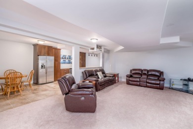 Experience refined waterfront living at its finest with this on Tullymore Golf Club in Michigan - for sale on GolfHomes.com, golf home, golf lot