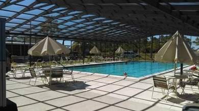 Welcome to your perfect retirement oasis in the charming city of on Herons Glen Golf and Country Club in Florida - for sale on GolfHomes.com, golf home, golf lot