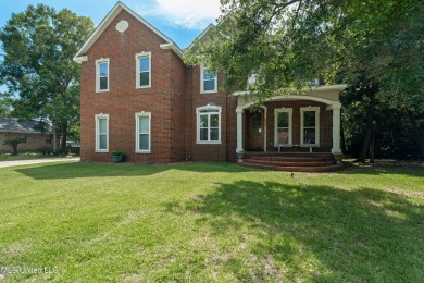 Nestled alongside the greens of the Pascagoula Country Club golf on Pascagoula Country Club in Mississippi - for sale on GolfHomes.com, golf home, golf lot