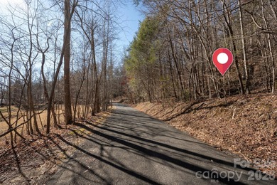 Come see this pretty, sloping lot with distant lake views on Rumbling Bald Resort on Lake Lure in North Carolina - for sale on GolfHomes.com, golf home, golf lot