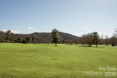 Come see this pretty, sloping lot with distant lake views on Rumbling Bald Resort on Lake Lure in North Carolina - for sale on GolfHomes.com, golf home, golf lot