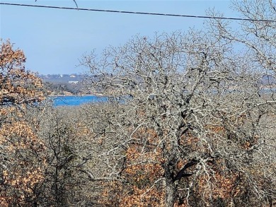 Beautiful corner lot build site with lake views and mature oak on Nocona Hills Golf Course in Texas - for sale on GolfHomes.com, golf home, golf lot