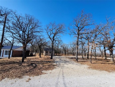 Beautiful corner lot build site with lake views and mature oak on Nocona Hills Golf Course in Texas - for sale on GolfHomes.com, golf home, golf lot