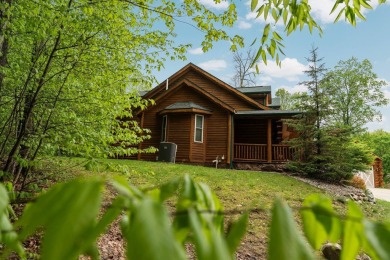 Stunning, custom-built log home overlooking the 16th tee & on Cedar River Golf Course in Michigan - for sale on GolfHomes.com, golf home, golf lot