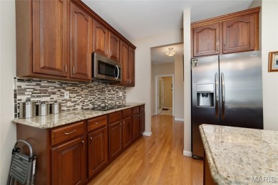 STUNNING 1.5 story villa overlooking the 8th green of on Winghaven Country Club in Missouri - for sale on GolfHomes.com, golf home, golf lot