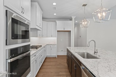 Settle into the ease of coastal living with this thoughtfully on River Landing Golf Course in North Carolina - for sale on GolfHomes.com, golf home, golf lot