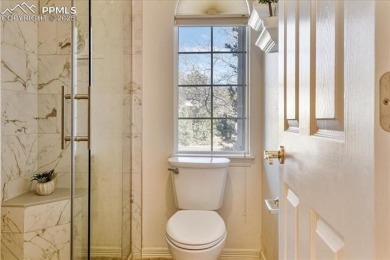 Exquisitely located on the edge of 22 acres of HOA owned forest on The Ridge At Castle Pines North in Colorado - for sale on GolfHomes.com, golf home, golf lot