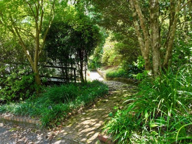 Step into a Southern storybook. Nestled beneath a canopy of on Jackson Links Golf Course in Alabama - for sale on GolfHomes.com, golf home, golf lot