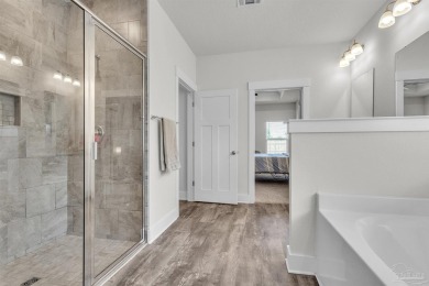 This beautifully designed 4-bedroom, 3-bathroom home with a on Tiger Point Golf and Country Club in Florida - for sale on GolfHomes.com, golf home, golf lot