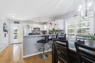 Desirable corner 'B' unit with split bedrooms and sweeping lake on The American Golf Club in Florida - for sale on GolfHomes.com, golf home, golf lot