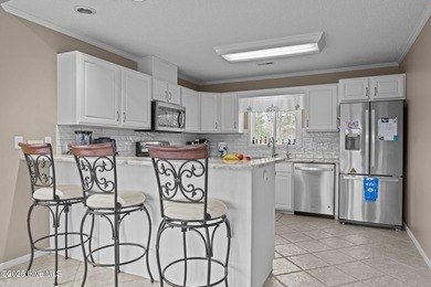 Stunning 4-bedroom, 3.5-bathroom home nestled on Hole 15 of the on Brandywine Bay Golf Club in North Carolina - for sale on GolfHomes.com, golf home, golf lot