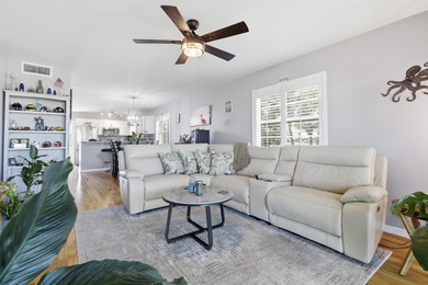 Desirable corner 'B' unit with split bedrooms and sweeping lake on The American Golf Club in Florida - for sale on GolfHomes.com, golf home, golf lot